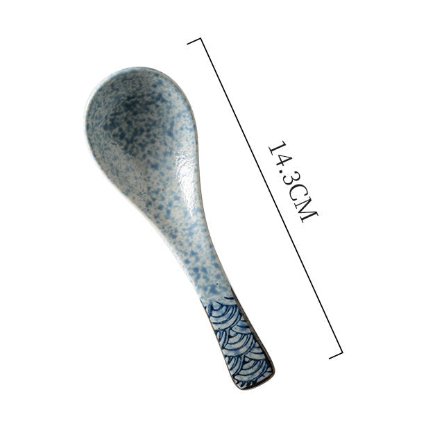 Ceramic spoon with blue speckled pattern and measurement label on a white background