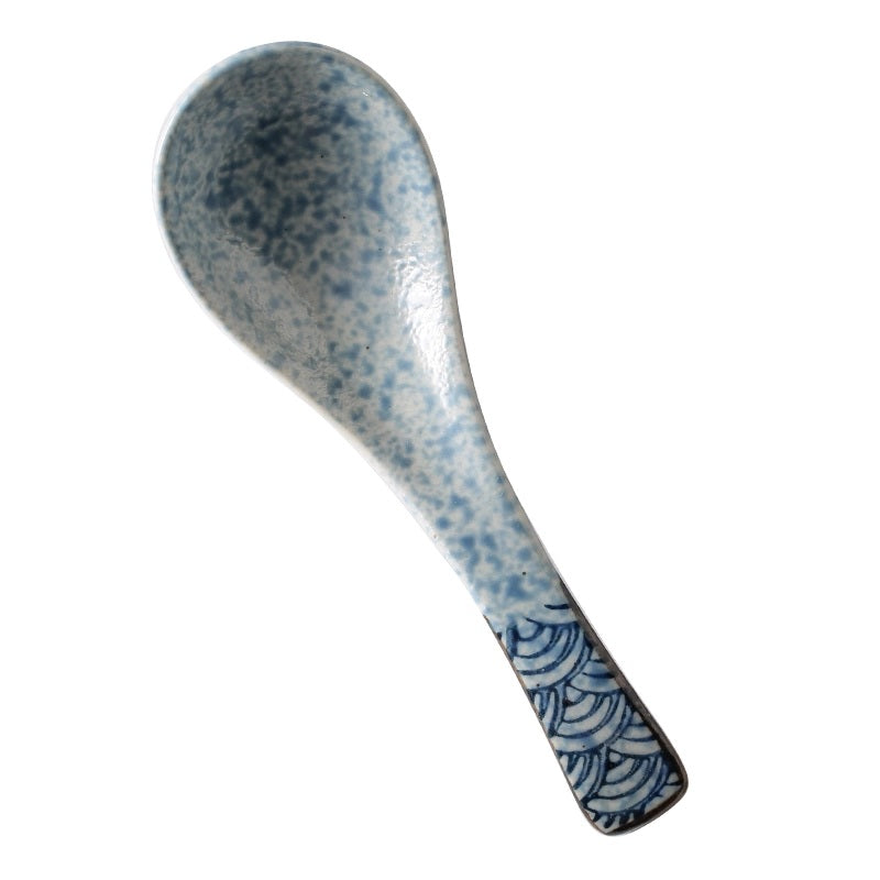 Spatula with blue speckled pattern on a white background