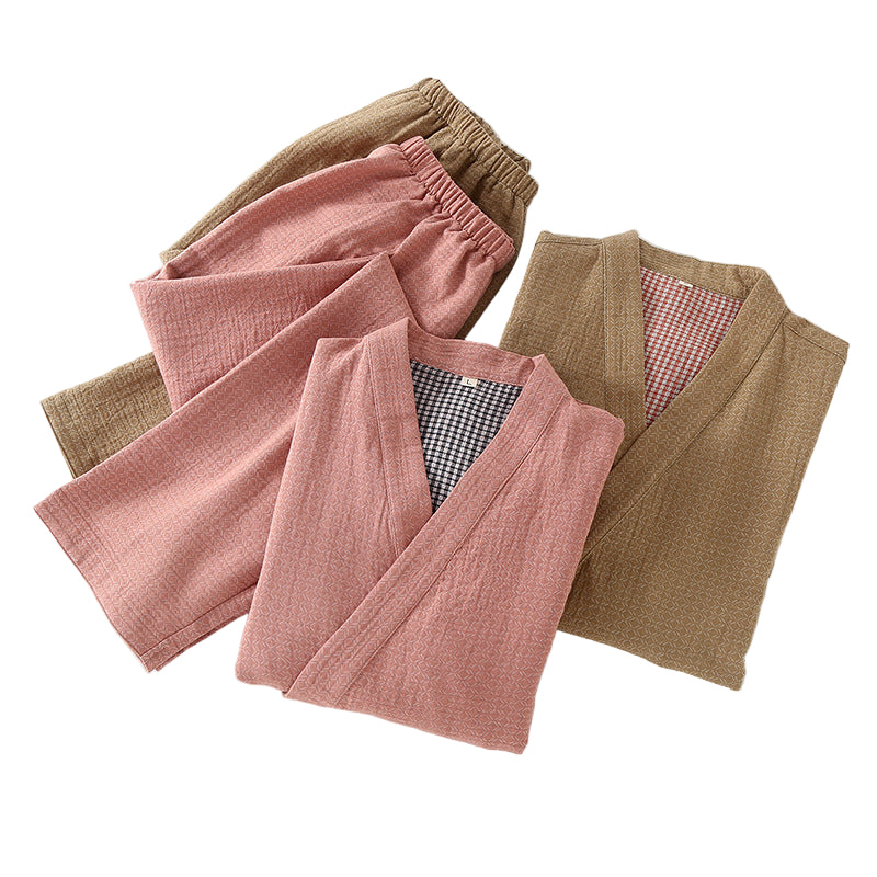 Folded pink and brown garments on a white surface