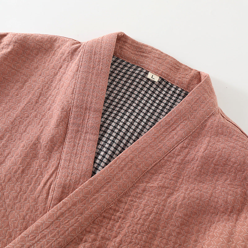 Close-up of a pink robe with a checkered lining on a white background