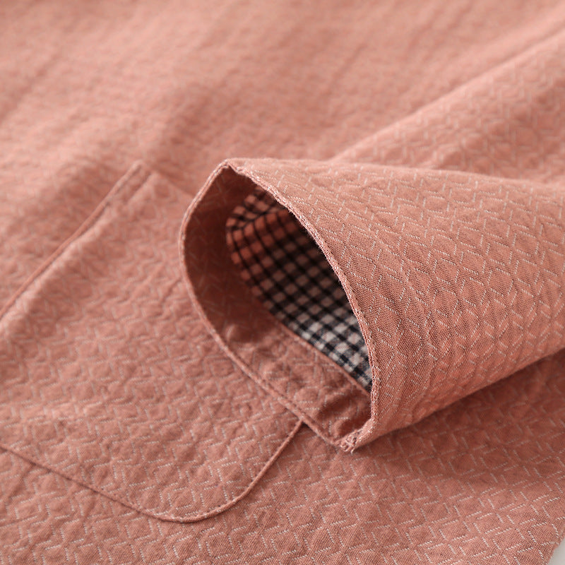 Close-up of a pink textured fabric with a checkered lining.