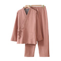 Pink checkered pajama set hanging on a a white wall 