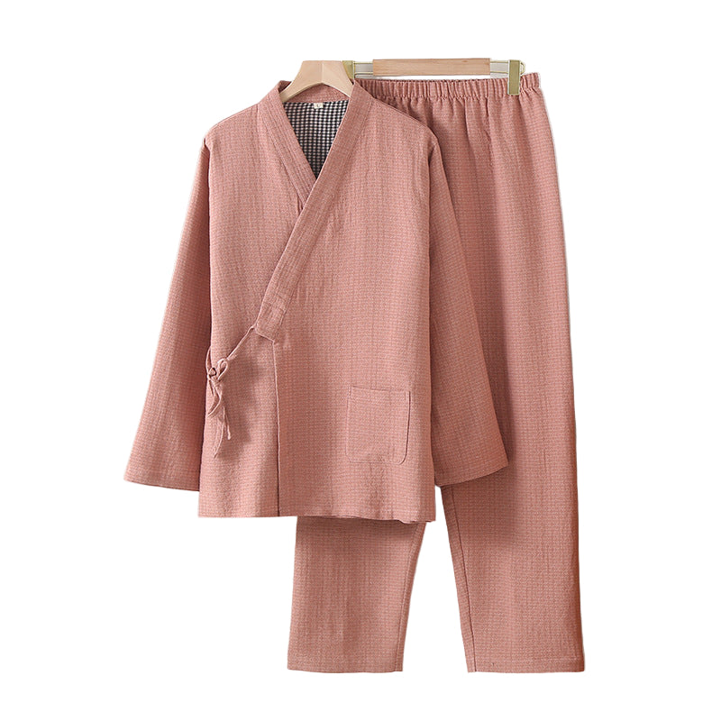 Pink checkered pajama set hanging on a a white wall 