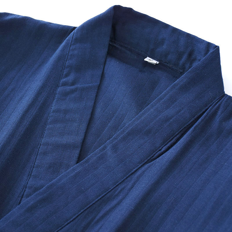 Close-up of a blue robe with a visible brand label on a white background