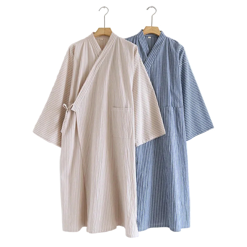 Two striped kimono-style robes hanging on wooden hangers against a plain white wall. The front robe is light beige with thin vertical stripes, and the back robe is blue with thin vertical stripes.