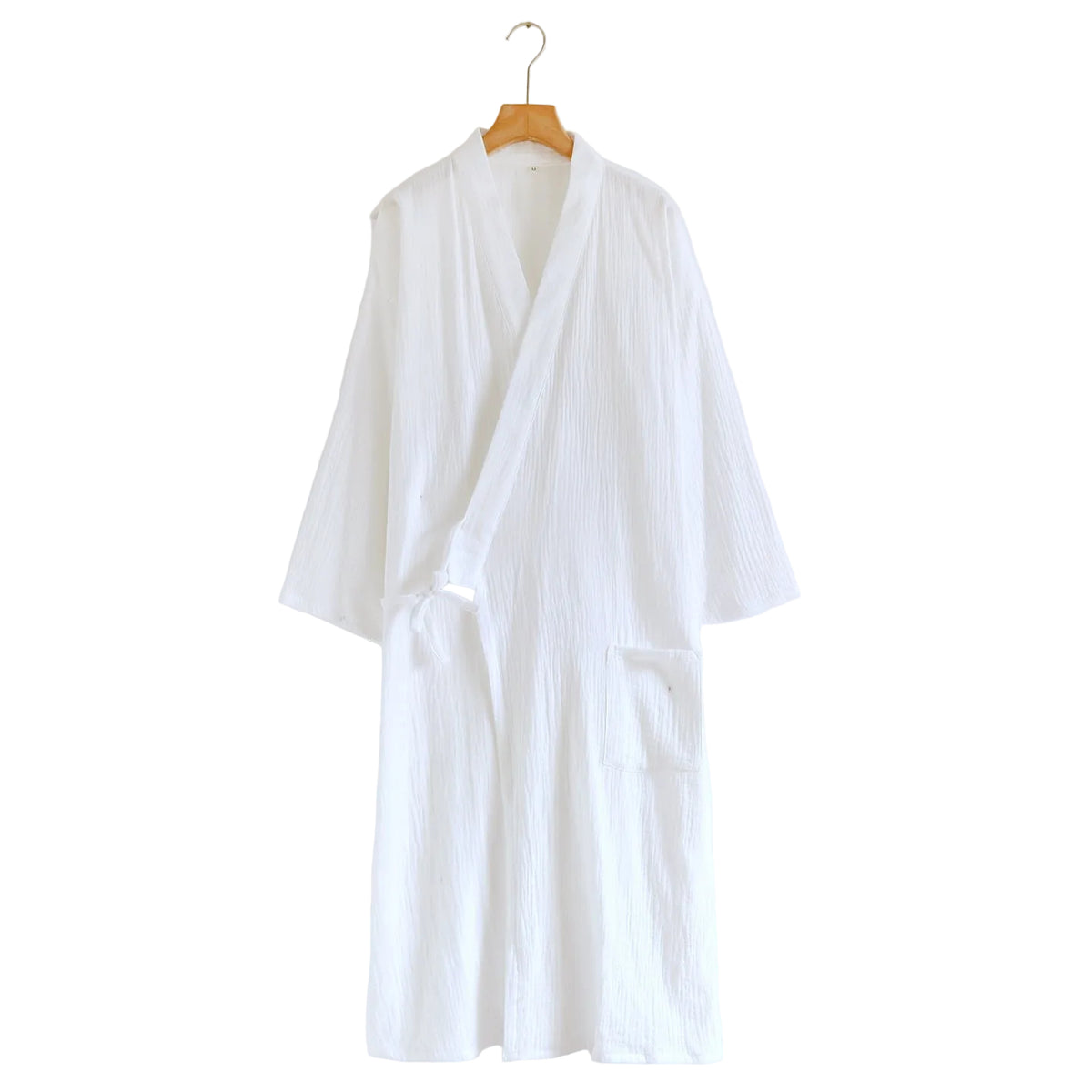 A white crinkle-textured cotton robe with a shawl collar and tie belt, hanging on a wooden hanger against a plain white wall.