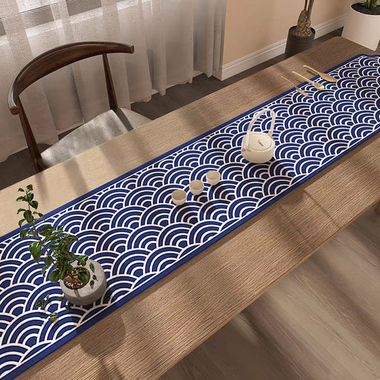 Table runner with blue wave pattern on a wooden table