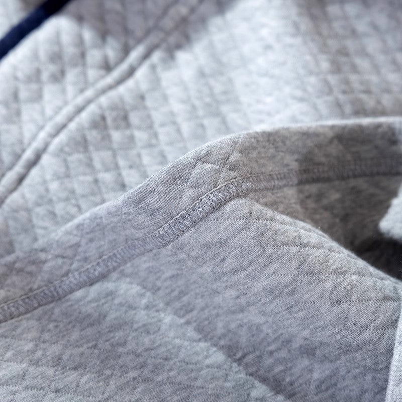 Close-up of gray quilted fabric with stitching details