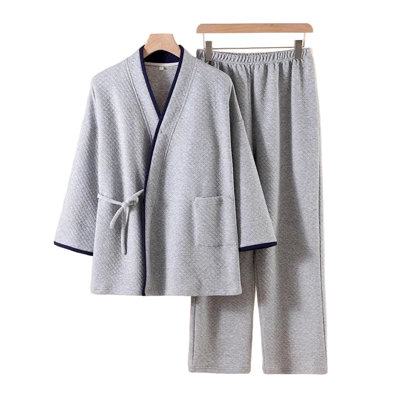 Gray pajama set with navy trim on a beige background