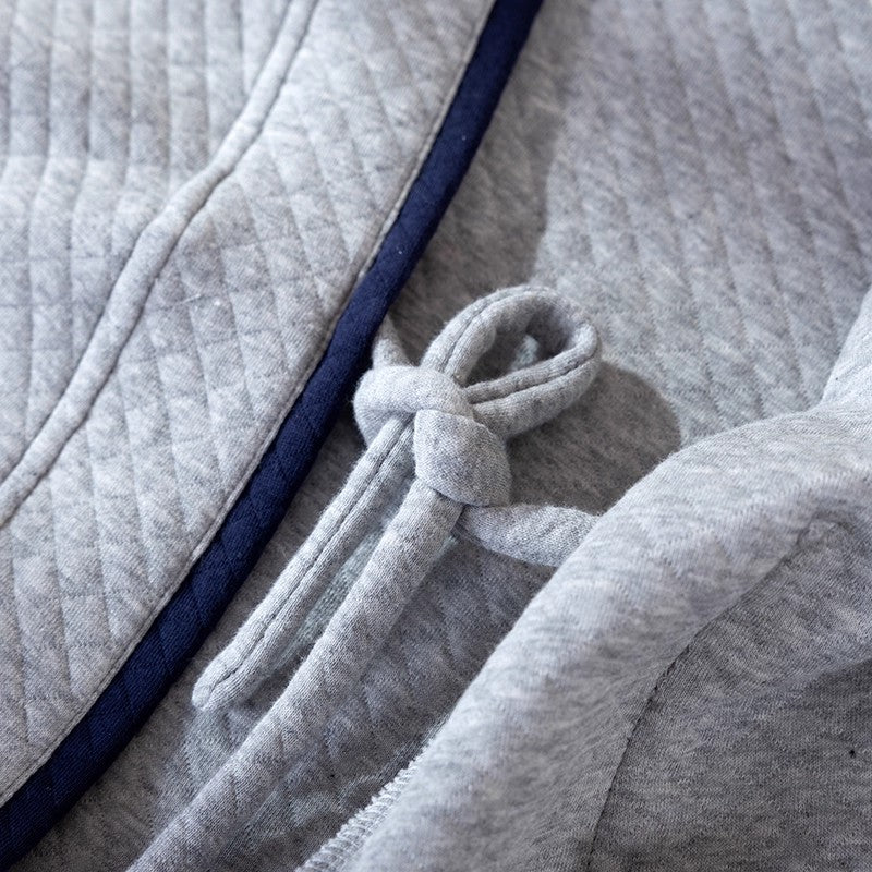 Gray textured fabric with a navy border and tied knot