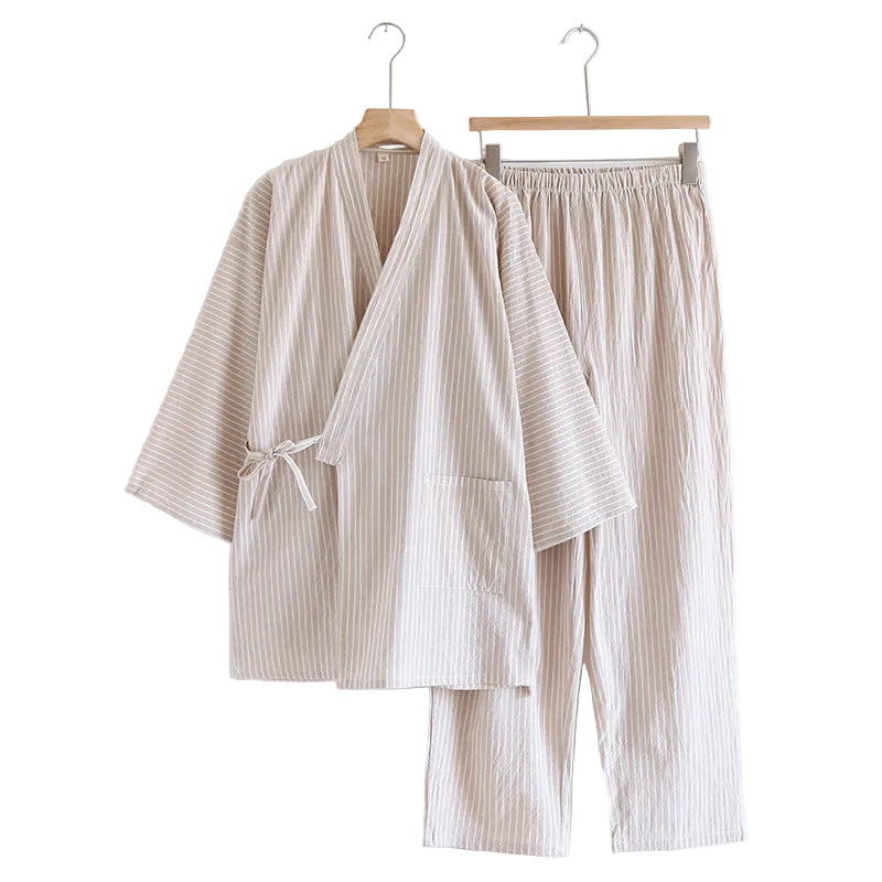 Beige striped robe and pants set hanging on wooden hangers against a white background